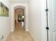 Hallway with arched entryways, neutral paint, tile floors, leading to living areas at 4748 Ballast Crest Cv, Land O Lakes, FL 34638
