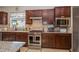 Gourmet kitchen featuring stainless steel appliances, granite countertops, and ample cabinet space at 4748 Ballast Crest Cv, Land O Lakes, FL 34638