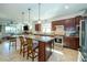 Large open kitchen with bar seating, stainless steel appliances, and seamless flow to the living room at 4748 Ballast Crest Cv, Land O Lakes, FL 34638
