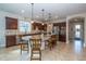 Spacious kitchen with dark wood cabinets, granite countertops, and a large central island with seating at 4748 Ballast Crest Cv, Land O Lakes, FL 34638
