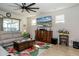 Well-lit living room with comfortable seating, entertainment center, and a view of the outdoor pool area at 4748 Ballast Crest Cv, Land O Lakes, FL 34638