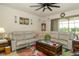 Inviting living room with a large sectional sofa, a floral rug, and a bright, airy atmosphere at 4748 Ballast Crest Cv, Land O Lakes, FL 34638