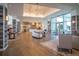 Lobby features wood flooring, exposed wood beams, and a stylish light fixture at 4748 Ballast Crest Cv, Land O Lakes, FL 34638