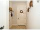 Mud room features ceramic tile flooring, white walls, a coat rack and a white interior door at 4748 Ballast Crest Cv, Land O Lakes, FL 34638