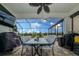 Covered patio with a dining table, an outdoor kitchen and views of the screened-in pool at 4748 Ballast Crest Cv, Land O Lakes, FL 34638