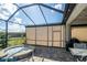 Screened-in patio features an outdoor kitchen and a view of the landscaped backyard at 4748 Ballast Crest Cv, Land O Lakes, FL 34638