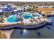 Breathtaking aerial view of the resort-style community pool and deck overlooking the lake at 4748 Ballast Crest Cv, Land O Lakes, FL 34638