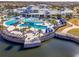 Enjoy this aerial shot of a pristine community pool and deck with lakeside views at 4748 Ballast Crest Cv, Land O Lakes, FL 34638