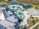 Stunning aerial view of the community resort-style pool and amenities by the lake at 4748 Ballast Crest Cv, Land O Lakes, FL 34638