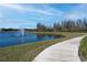 Scenic community walking trail with a water view and fountain feature at 4748 Ballast Crest Cv, Land O Lakes, FL 34638