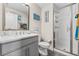 Bathroom with gray vanity, white subway tile shower, and mirror at 5351 Bridge St # 67, Tampa, FL 33611