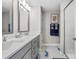 Stylish bathroom featuring double sinks, granite counters, and a glass shower at 5351 Bridge St # 67, Tampa, FL 33611