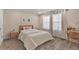 Bright bedroom features wood-look floors, a platform bed, and a small writing desk at 5351 Bridge St # 67, Tampa, FL 33611