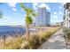 Picturesque waterfront view with a modern high-rise condominium tower in a vibrant community at 5351 Bridge St # 67, Tampa, FL 33611