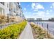Scenic waterfront view along a well-maintained walkway adjacent to modern condos in an upscale neighborhood at 5351 Bridge St # 67, Tampa, FL 33611