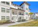 Two-story white building with balconies, brown roof, and landscaping at 5351 Bridge St # 67, Tampa, FL 33611