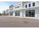 Exterior view of a white modern retail shopping center with sidewalks at 5351 Bridge St # 67, Tampa, FL 33611