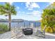 Relaxing patio with fire pit and chairs overlooking the water at 5351 Bridge St # 67, Tampa, FL 33611