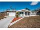 Charming single-story home with a well-maintained lawn and inviting front porch seating at 5405 Golden Nugget Dr, Holiday, FL 34690