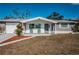 Charming home featuring brick accents, manicured landscaping, and a cozy front porch at 5405 Golden Nugget Dr, Holiday, FL 34690