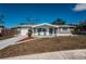 Charming single-story home with a well-maintained lawn and inviting front porch seating at 5405 Golden Nugget Dr, Holiday, FL 34690