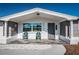 Inviting front porch seating area with white rock and tile at 5405 Golden Nugget Dr, Holiday, FL 34690