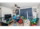 An interior room filled with toys, featuring light wood flooring and a ceiling fan at 5405 Golden Nugget Dr, Holiday, FL 34690