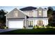 Charming two-story home with modern farmhouse design, manicured lawn, and inviting curb appeal at 5703 S Macdill Ave, Tampa, FL 33611