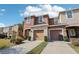 Two-story townhome with attached garage and landscaping at 7069 Towne Lake Rd, Riverview, FL 33578