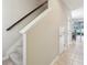 Staircase with carpeted steps and dark wood railing at 7069 Towne Lake Rd, Riverview, FL 33578