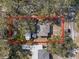 An aerial view showcasing a cozy single-story home nestled among mature trees at 738 59Th Ne Ave, St Petersburg, FL 33703