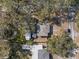 A single-story house has a fenced backyard, multiple sheds, and mature trees that surround the property at 738 59Th Ne Ave, St Petersburg, FL 33703