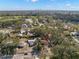 A picturesque aerial view of a single-story home with mature trees and an open field in the distance at 738 59Th Ne Ave, St Petersburg, FL 33703
