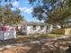 Side view of a bright single-story home featuring neat landscaping at 738 59Th Ne Ave, St Petersburg, FL 33703