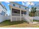 Charming home with a spacious screened porch and stairs leading to the backyard at 7715 S Obrien St, Tampa, FL 33616