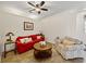 Cozy living room with a red sofa and striped armchair at 8784 Ashworth Dr, Tampa, FL 33647