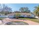 Single-story home with circular driveway, attached garage, and landscaped lawn at 108 19Th St, Belleair Beach, FL 33786