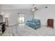 Spacious living room featuring tile floors, ceiling fan, and sliding glass doors to the outdoor space at 11045 Springridge Dr, Tampa, FL 33624