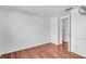 This bedroom has hardwood floors, a ceiling fan, and a closet at 1137 King Arthur Ct # 510, Dunedin, FL 34698