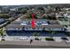 Exterior view of the building with manicured landscaping, palm trees, and parking at 1137 King Arthur Ct # 510, Dunedin, FL 34698