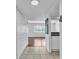 Hallway leading to a living area with tile floors and a view of the kitchen at 1137 King Arthur Ct # 510, Dunedin, FL 34698