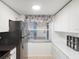 Modern kitchen featuring white cabinets, sleek appliances, and a bright window at 1137 King Arthur Ct # 510, Dunedin, FL 34698
