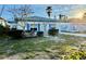 Front view of a single story home with a yard at 119 11Th Ave, Indian Rocks Beach, FL 33785