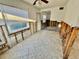 Image shows exposed framing and tile floors, large window, and a door in a kitchen area for a property for sale at 119 11Th Ave, Indian Rocks Beach, FL 33785
