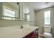 Bathroom with toilet, vanity, and a window at 13017 Manatee Ave, New Port Richey, FL 34654