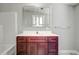 Bathroom with dark wood vanity and updated fixtures at 13017 Manatee Ave, New Port Richey, FL 34654