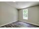Bedroom with wood-look floors and a window at 13017 Manatee Ave, New Port Richey, FL 34654