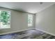 Bright bedroom with wood-look floors and large windows at 13017 Manatee Ave, New Port Richey, FL 34654