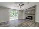Living area with gray flooring, fireplace, and sliding glass doors at 13017 Manatee Ave, New Port Richey, FL 34654