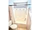 Bright bathroom features a shower and bath combination and white shower curtain at 145 Blue Marlin Dr, Oldsmar, FL 34677